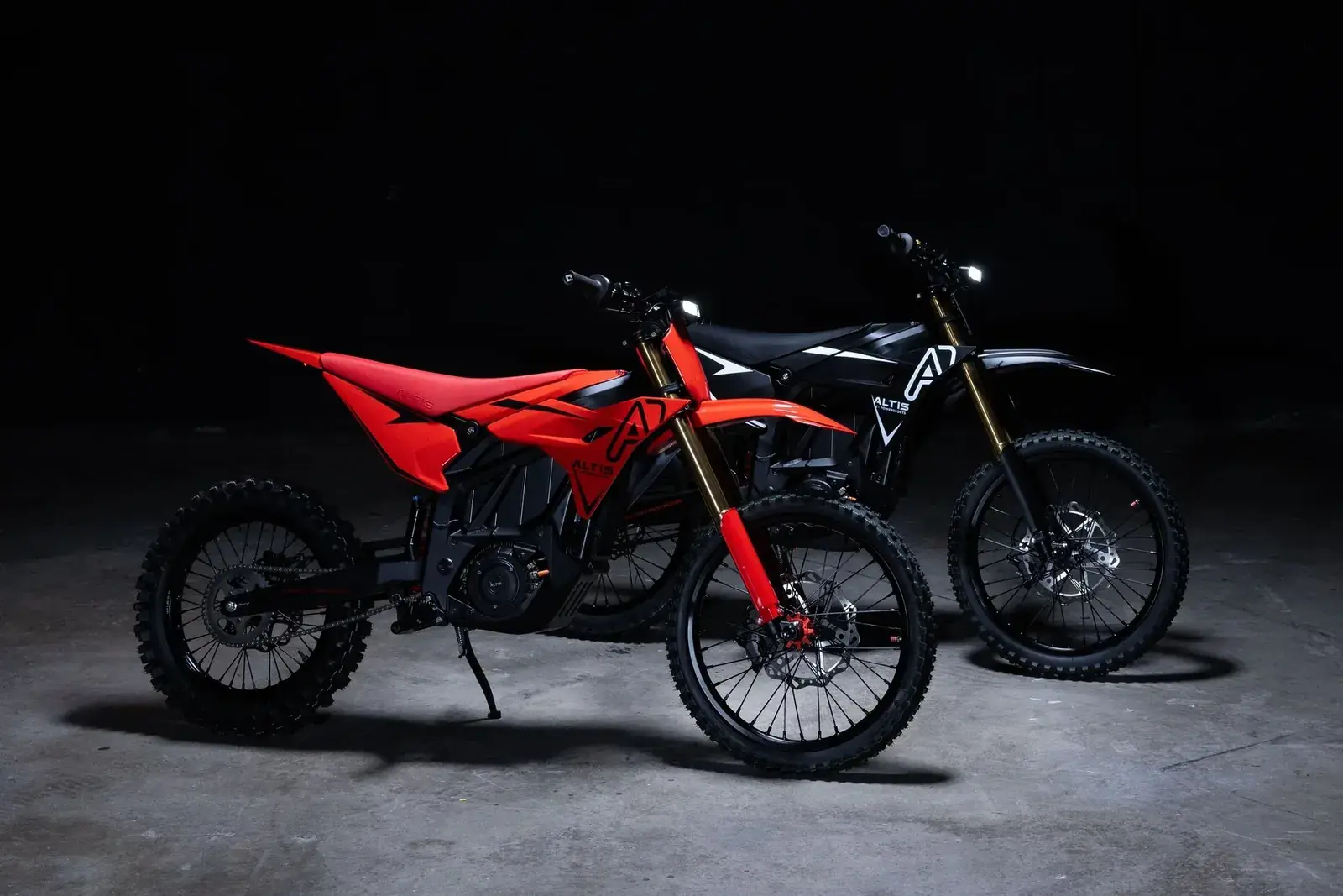 Altis electric motorcycles staged in a dark studio