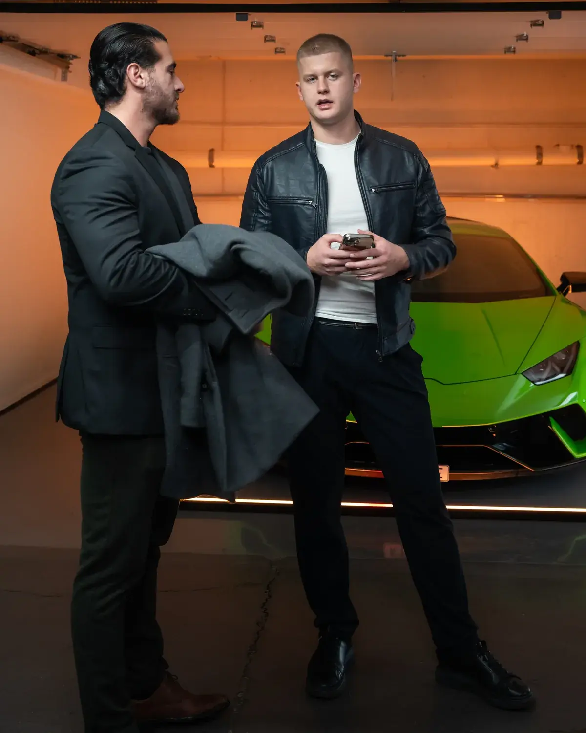 Nordic Motors conversation beside a green showroom car