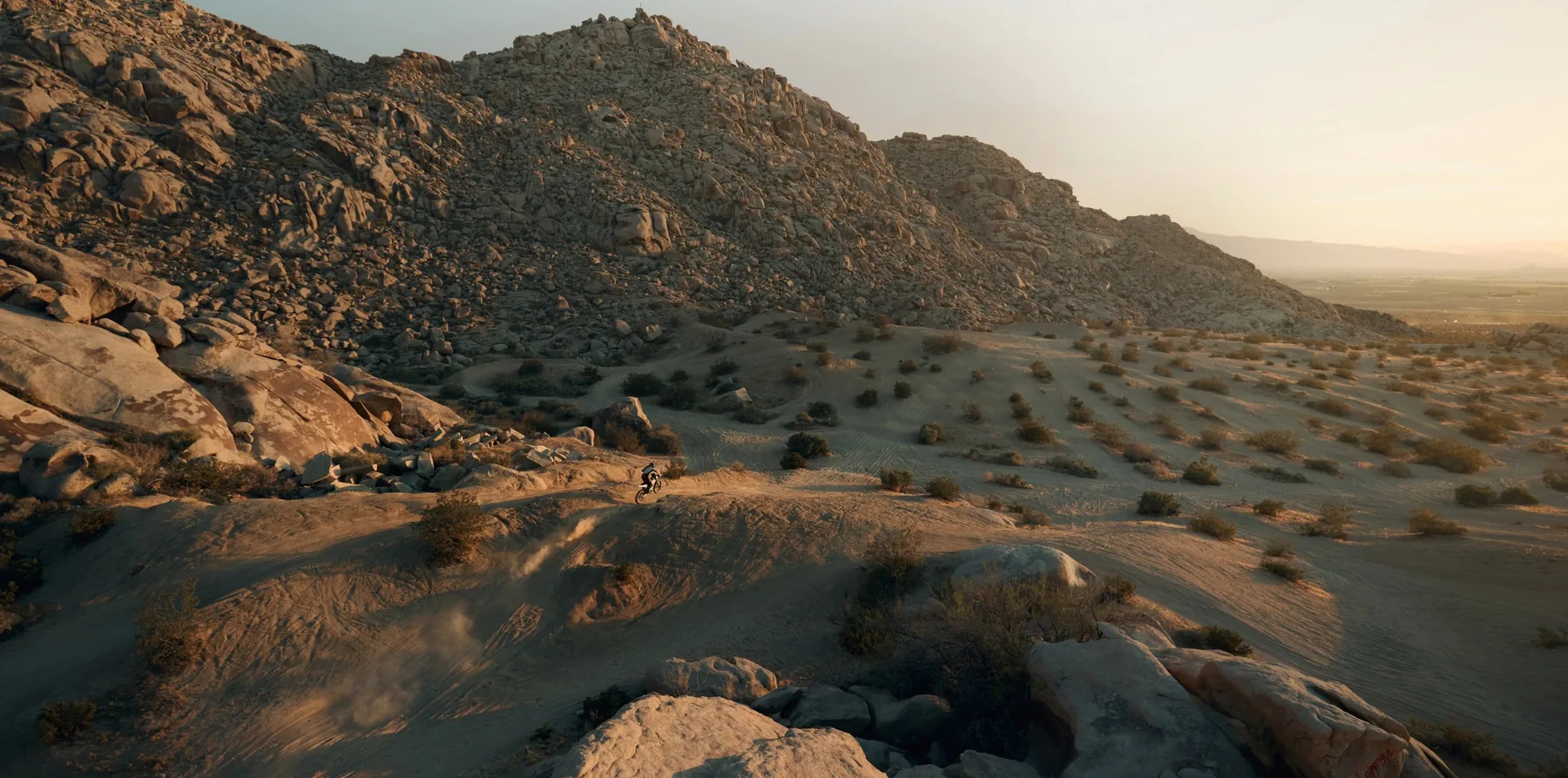 805 RX riding across rocky desert terrain