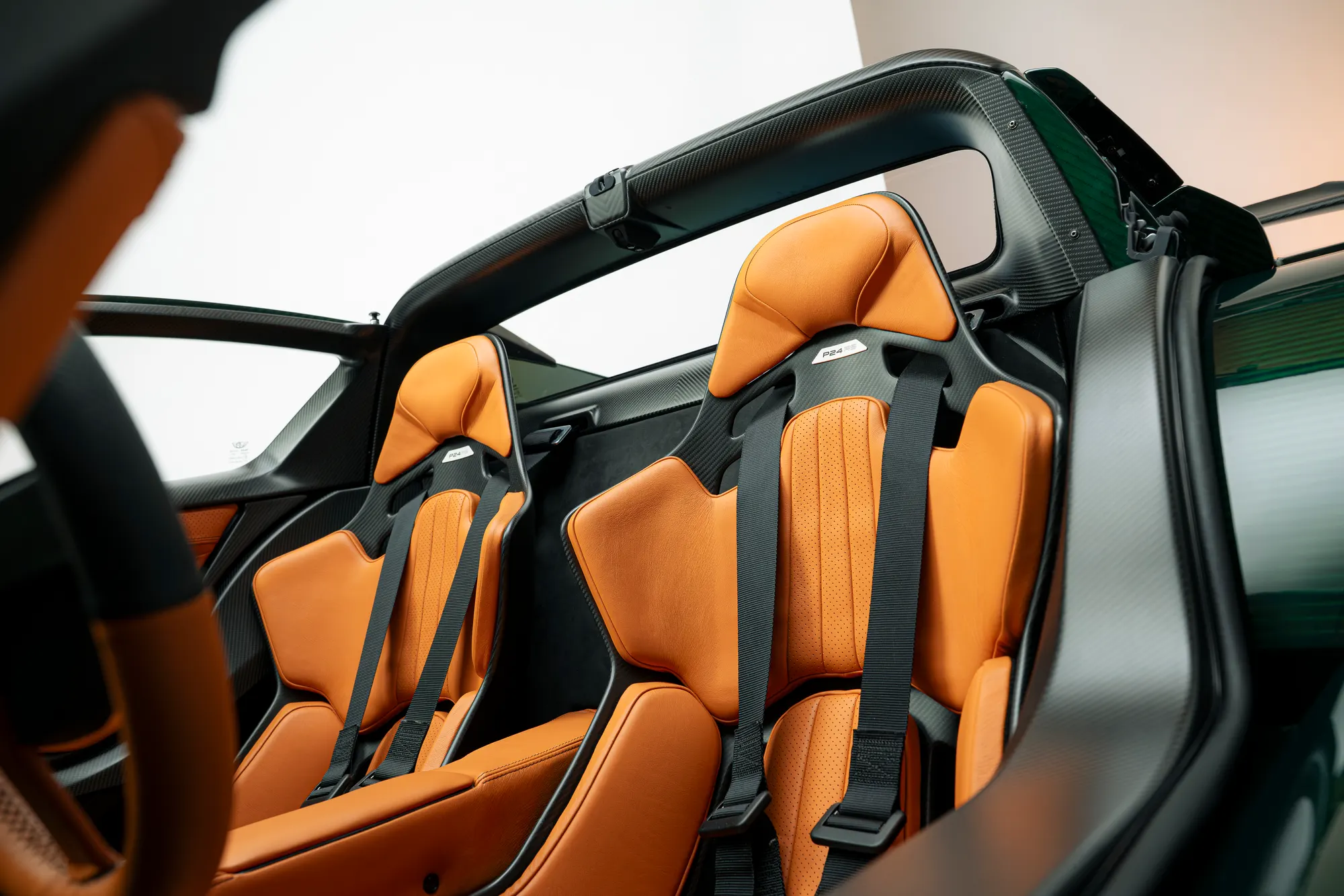 P24 RS carbon seats with orange leather and six-point harnesses