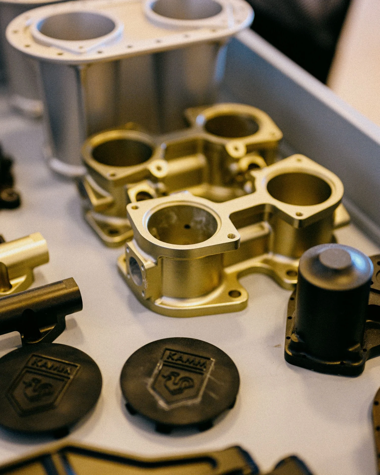 Machined engine components arranged on a workshop table