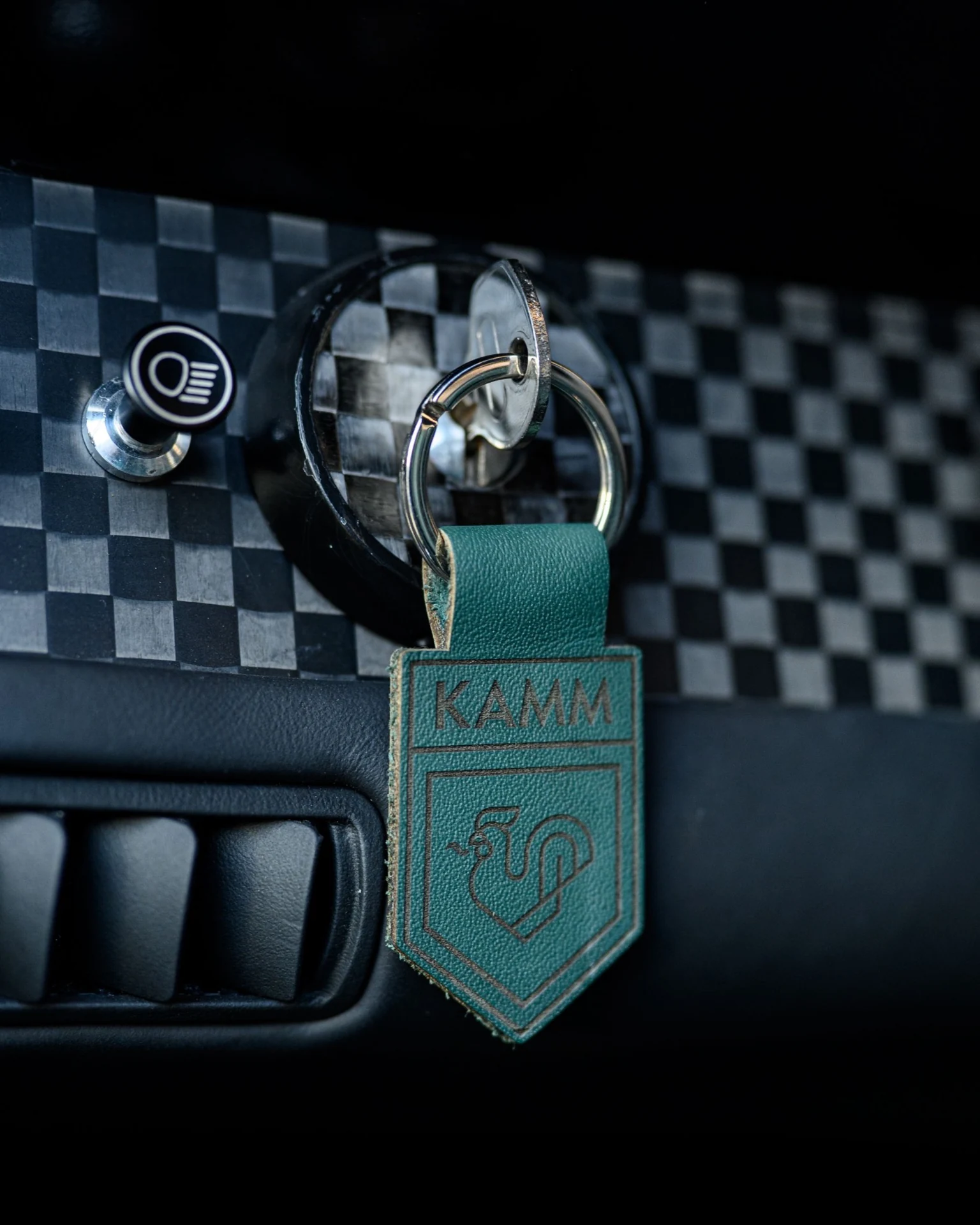 KAMM leather key fob beside the ignition and checked dashboard