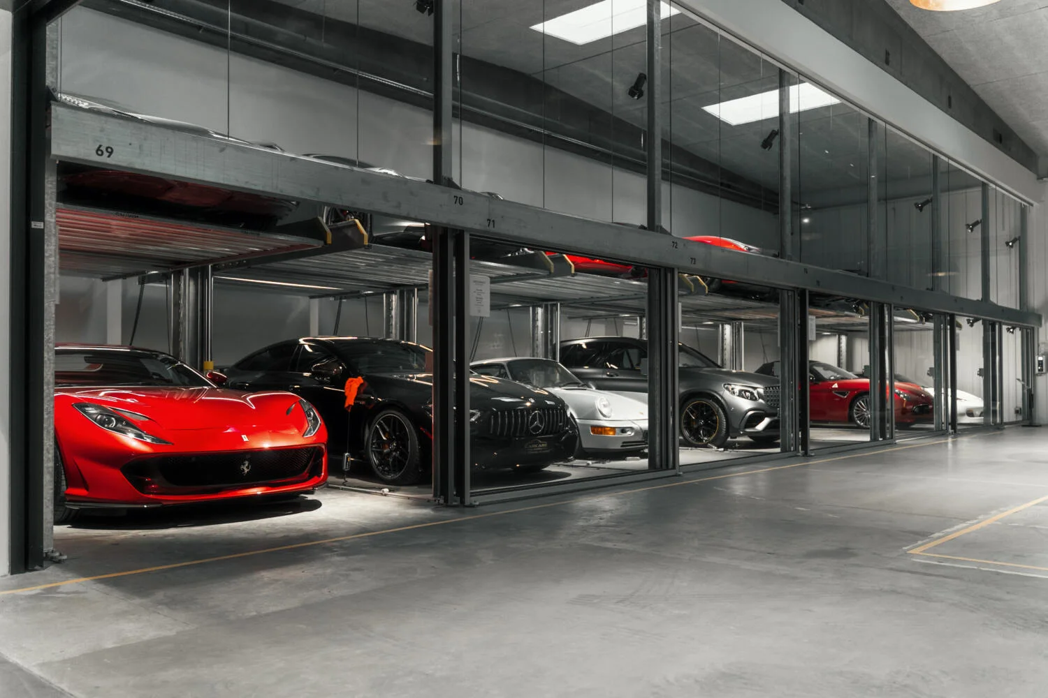 Ferrari and collector cars in the glass storage garages at MY GARAGE