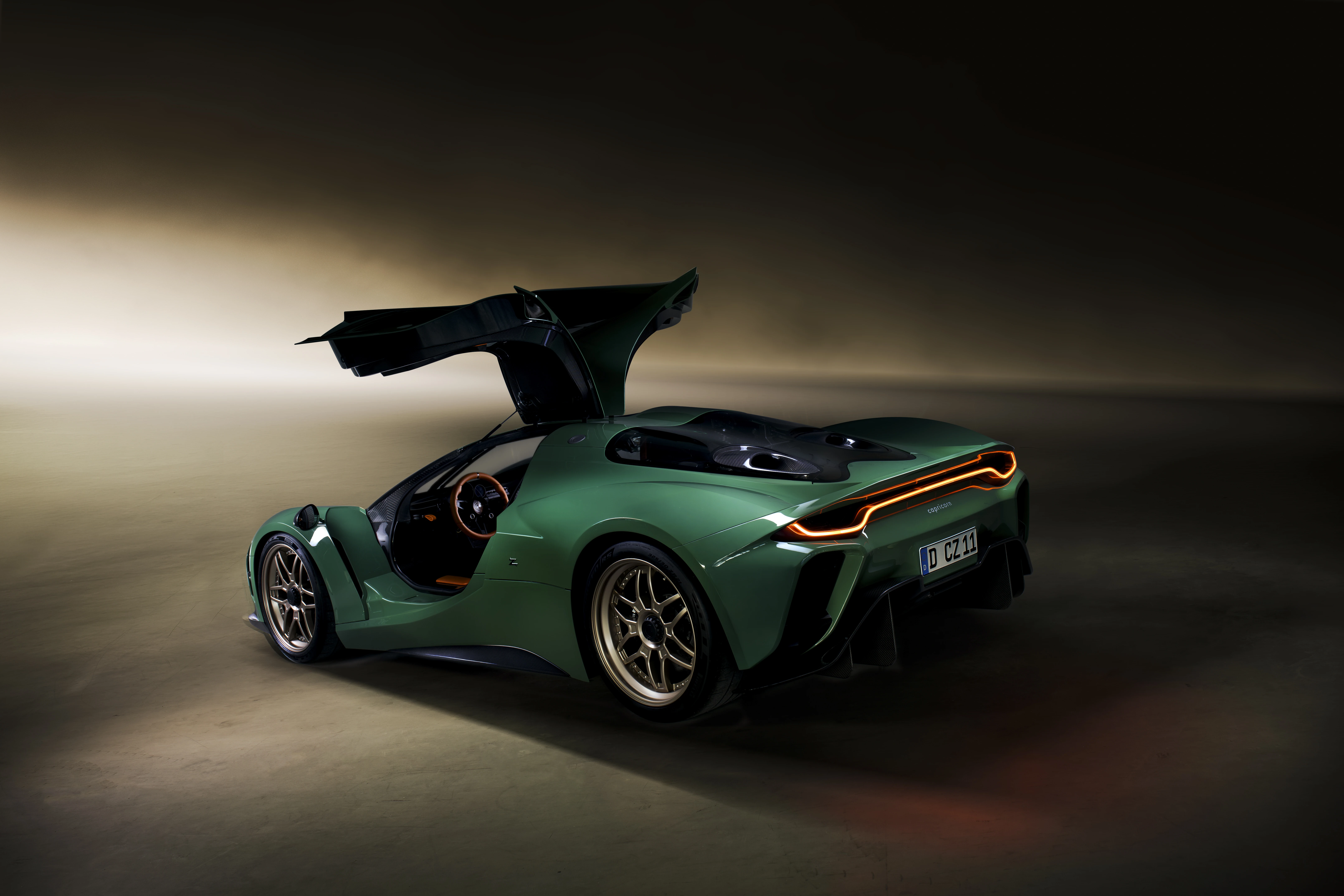 Rear view of the green Capricorn Zagato with both doors raised, showing its body architecture