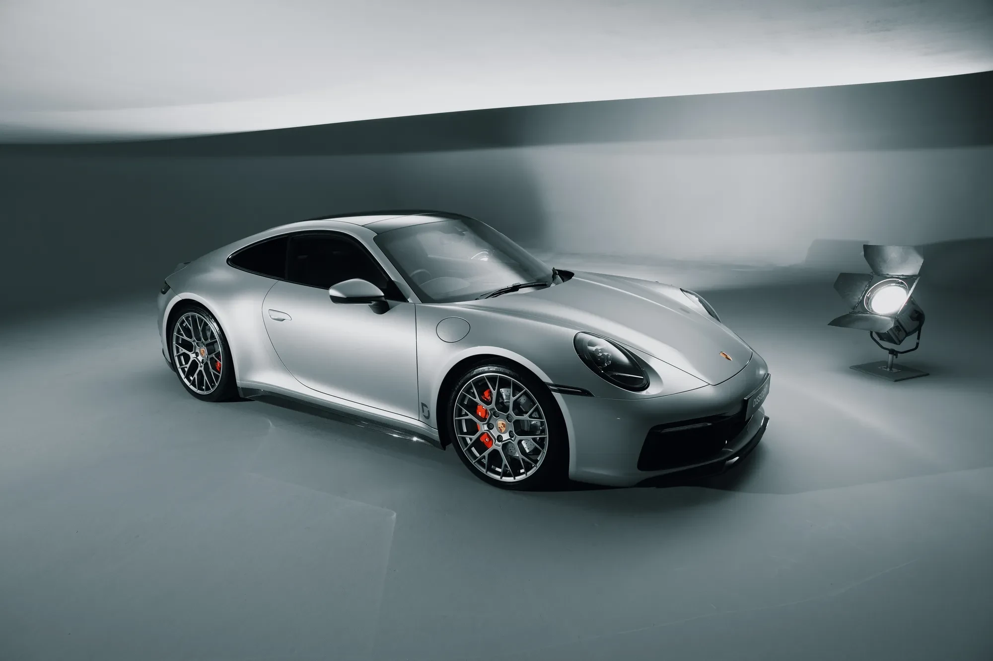 Complete silver Porsche 911 fitted with Dissident components in a studio