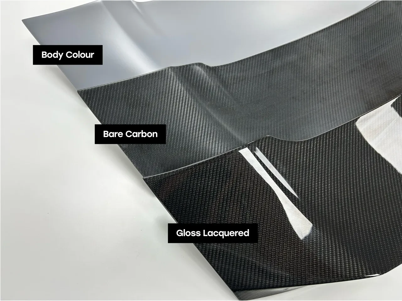 Dissident material samples comparing body colour, bare carbon and gloss lacquer