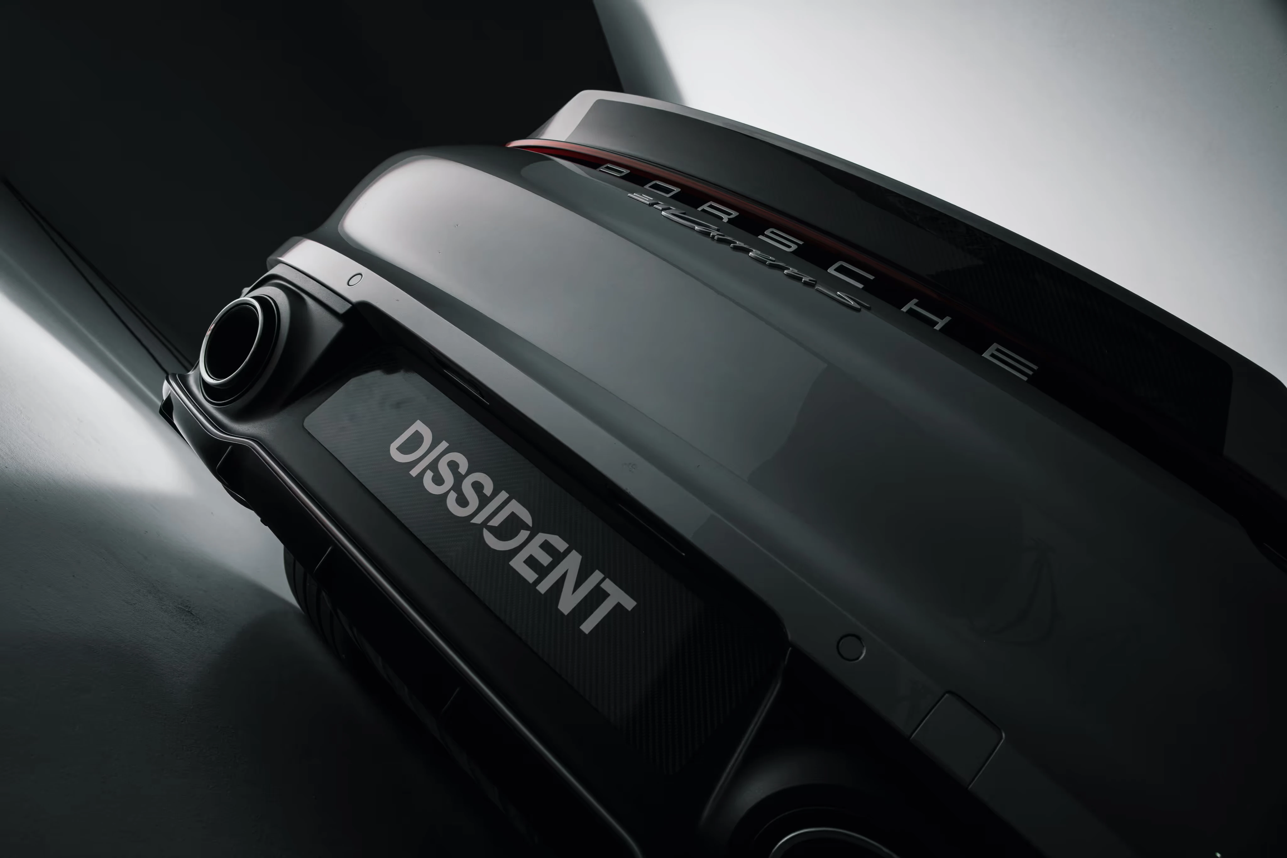 Dissident Porsche 911 rear bodywork, exhaust and carbon ducktail in a dark studio